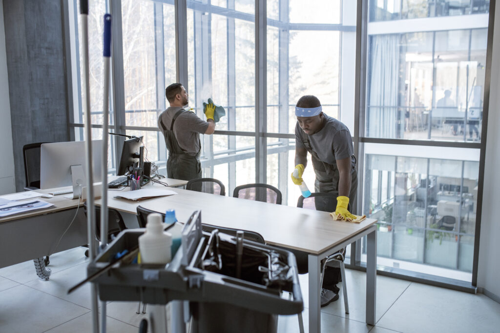 office cleaning services team sanitizing desks, keyboards, and high-touch areas