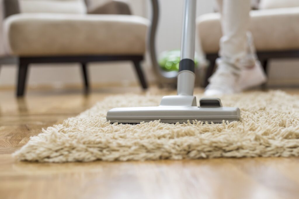 A closeup of a vacuum cleaner at a living room-Expert carpet cleaning services in hotel corridors